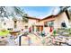 Backyard with a multi-level patio, hot tub, seating, and views of the surrounding landscape at 974 Spring Ranch Dr, Golden, CO 80401