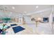 Large basement gym with mirrored wall, exercise equipment, access to a kitchenette and ping pong table at 974 Spring Ranch Dr, Golden, CO 80401