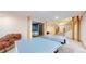 Spacious basement featuring a ping pong table, exposed support beams and access to the bedroom and upper floor at 974 Spring Ranch Dr, Golden, CO 80401