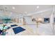 Large basement gym with mirrored wall, hardwood floors, and adjoining carpeted rec space at 974 Spring Ranch Dr, Golden, CO 80401