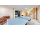 Open basement featuring a ping pong table, basement bedroom, and carpeted staircase at 974 Spring Ranch Dr, Golden, CO 80401