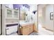 Well-lit bathroom with a modern vanity, mirror, and a separate toilet area at 974 Spring Ranch Dr, Golden, CO 80401