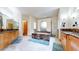 Luxurious bathroom with dual vanities, marble counters, a jetted tub, and stone flooring at 974 Spring Ranch Dr, Golden, CO 80401
