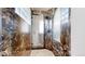 Luxurious marble shower room featuring frameless glass doors, mosaic floors, and dual shower heads at 974 Spring Ranch Dr, Golden, CO 80401
