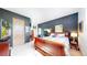 Well-lit bedroom with dark accent wall, wood furniture, and view of the outdoors at 974 Spring Ranch Dr, Golden, CO 80401