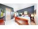 Well-lit bedroom featuring a sleigh bed, bedside table, and calming dark wall at 974 Spring Ranch Dr, Golden, CO 80401