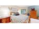 Bright bedroom with a wooden bed frame, desk, and a view of the lush outdoors at 974 Spring Ranch Dr, Golden, CO 80401