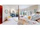 Spacious bedroom with fireplace, four-poster bed, and scenic outdoor views from the bay windows at 974 Spring Ranch Dr, Golden, CO 80401