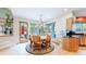 Bright dining area features a circular table, soft-covered chairs, and views of the outdoor scenery at 974 Spring Ranch Dr, Golden, CO 80401