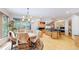 Sunlit dining area featuring hardwood floors, large windows, and direct access to the modern kitchen at 974 Spring Ranch Dr, Golden, CO 80401