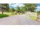 Beautiful exterior with lush, mature landscaping along the winding driveway at 974 Spring Ranch Dr, Golden, CO 80401