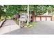 Exterior elevation with stone accents, mature trees and a three-car garage at 974 Spring Ranch Dr, Golden, CO 80401