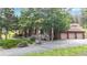 Charming home exterior with mature trees and a three-car garage at 974 Spring Ranch Dr, Golden, CO 80401