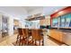 Kitchen with stainless steel appliances, wooden cabinets, granite countertops and three bar stools at 974 Spring Ranch Dr, Golden, CO 80401
