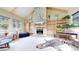 Cozy living room with vaulted ceilings, stone fireplace, built-in shelving, and large windows at 974 Spring Ranch Dr, Golden, CO 80401