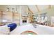 Comfortable living room with stone fireplace, built-in bookshelves, and large windows with natural light at 974 Spring Ranch Dr, Golden, CO 80401
