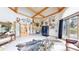 Large living room featuring a fireplace, beamed ceilings, and unique decor at 974 Spring Ranch Dr, Golden, CO 80401
