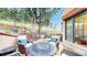 Spacious outdoor patio featuring a fire pit, comfortable seating, and serene forest views at 974 Spring Ranch Dr, Golden, CO 80401