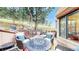 Outdoor living space featuring a patio, comfortable seating area with a fire pit, and wooded views at 974 Spring Ranch Dr, Golden, CO 80401