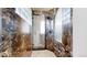 Modern shower with marble surround, glass door, and updated fixtures at 974 Spring Ranch Dr, Golden, CO 80401