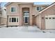 Two-story house front entrance with brick and siding, and a walkway at 89 Dawn Heath Cir, Littleton, CO 80127