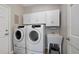 Bright laundry room, complete with washer, dryer, and utility sink at 89 Dawn Heath Cir, Littleton, CO 80127