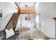 Open-concept dining area with modern table set, stylish light fixture, and staircase at 10985 W Alamo Pl, Littleton, CO 80127