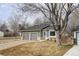 Charming home featuring a well-maintained lawn, two-car garage, and inviting front entrance at 10985 W Alamo Pl, Littleton, CO 80127