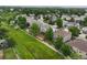 Aerial view of neighborhood, home and greenbelt with mature trees and landscaping at 15962 W 70Th Dr, Arvada, CO 80007