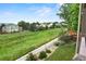 Greenbelt view from backyard with mature trees and a view of other houses in the neighborhood at 15962 W 70Th Dr, Arvada, CO 80007
