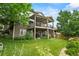 Multi-level deck and a lush backyard with mature trees and landscaping at 15962 W 70Th Dr, Arvada, CO 80007