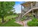 Multi-tiered backyard with patio and outdoor living area and lush lawn with mature landscaping at 15962 W 70Th Dr, Arvada, CO 80007
