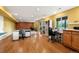 Finished basement with wood floors, multiple desks and work areas at 15962 W 70Th Dr, Arvada, CO 80007