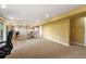 Large, carpeted basement area with work space and several storage spaces at 15962 W 70Th Dr, Arvada, CO 80007