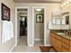 Bathroom vanity with double sinks and doors to a walk-in closet and water closet at 15962 W 70Th Dr, Arvada, CO 80007