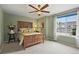 Charming bedroom with a decorative bed frame and large window at 15962 W 70Th Dr, Arvada, CO 80007