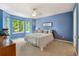 Bright blue bedroom with large window at 15962 W 70Th Dr, Arvada, CO 80007