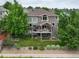 Exterior of home with a multi-level deck overlooking the backyard and landscaping at 15962 W 70Th Dr, Arvada, CO 80007