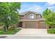 Charming two-story home with three-car garage, well-maintained lawn and brick accents at 15962 W 70Th Dr, Arvada, CO 80007