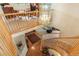 View from the upper level, showcasing the hardwood foyer with the curved staircase at 15962 W 70Th Dr, Arvada, CO 80007