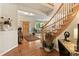 Welcoming foyer featuring a hardwood floor and a staircase leading up at 15962 W 70Th Dr, Arvada, CO 80007