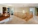 Hallway with office, staircase, carpeted floor and a chandelier, creating an airy and welcoming transition at 15962 W 70Th Dr, Arvada, CO 80007