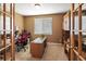 Office area featuring neutral walls, carpeted floors, a window with blinds, a desk and chair at 15962 W 70Th Dr, Arvada, CO 80007