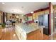 Open-concept kitchen with granite countertops, stainless steel appliances, and direct views into the living area at 15962 W 70Th Dr, Arvada, CO 80007