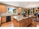Kitchen with stainless steel appliances, granite countertops, an island, hardwood floors and natural light at 15962 W 70Th Dr, Arvada, CO 80007