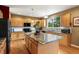 Bright kitchen with stainless appliances, granite countertops, a kitchen island and beautiful wood floors at 15962 W 70Th Dr, Arvada, CO 80007