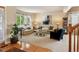 Bright living room with large bay windows, plush carpet, and comfortable seating at 15962 W 70Th Dr, Arvada, CO 80007