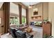 Inviting living room with a fireplace, tall windows, and comfortable seating arrangement at 15962 W 70Th Dr, Arvada, CO 80007
