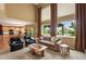 Spacious living room with high ceilings, large windows, and an open floor plan to the kitchen at 15962 W 70Th Dr, Arvada, CO 80007