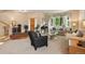 Inviting living room featuring a bay window, plush carpet, and ample seating at 15962 W 70Th Dr, Arvada, CO 80007